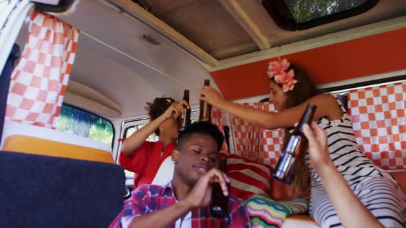 Group of friends toasting beer bottles