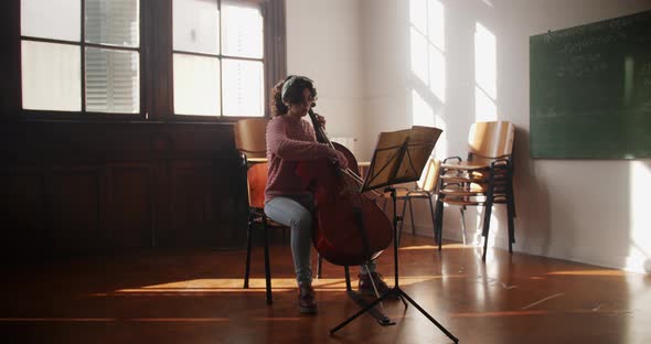 Cellist Rehearsing In Classroom