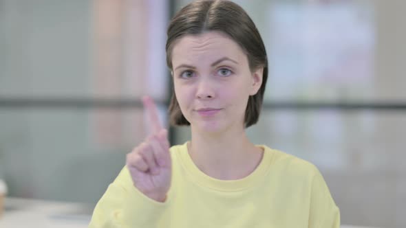 Portrait of Young Woman Showing No Sign By Finger Denial