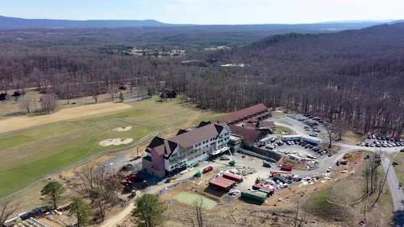 Aerial ascent with camera tilt down showing Cacapon State Park lodge expansion construction project