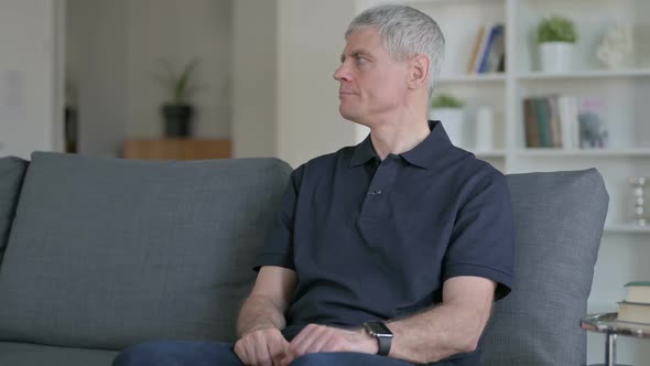 Impatient Middle Aged Businessman Waiting at Home