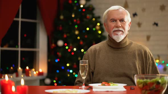 Sad Man Celebrating Xmas Alone, Looking to Camera, Social Services for Retirees