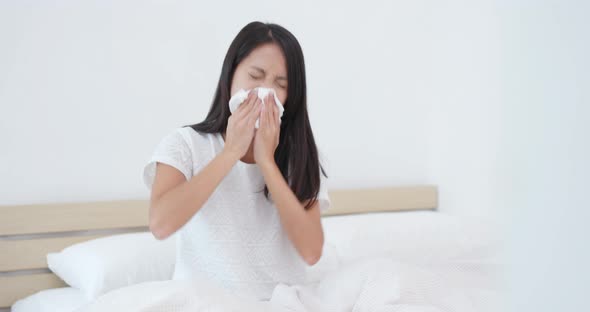 Woman sneeze on bed