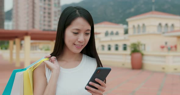 Woman use of mobile phone in city