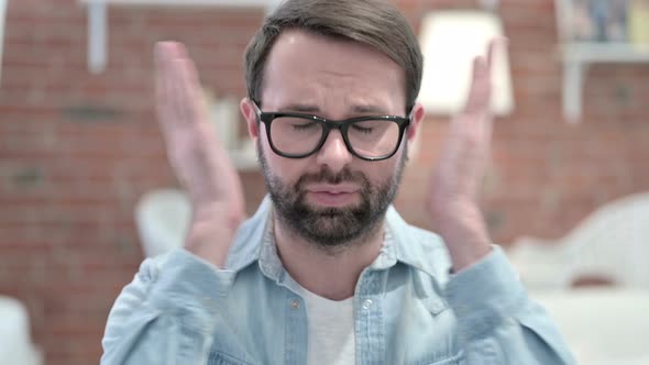 Portrait of Beard Young Man Reacting To Failure in Loft Office 