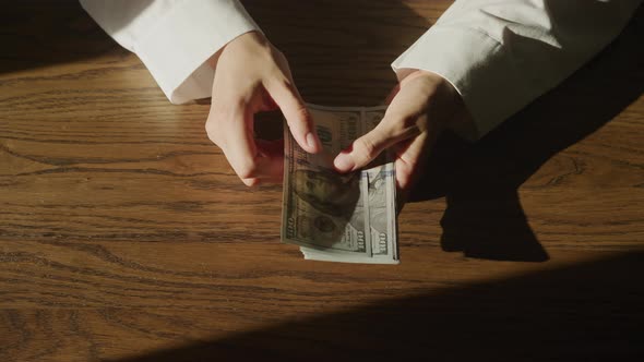 Top View of Caucasian Woman Hands Counting Cash Money Dollar Bills in Slow Motion