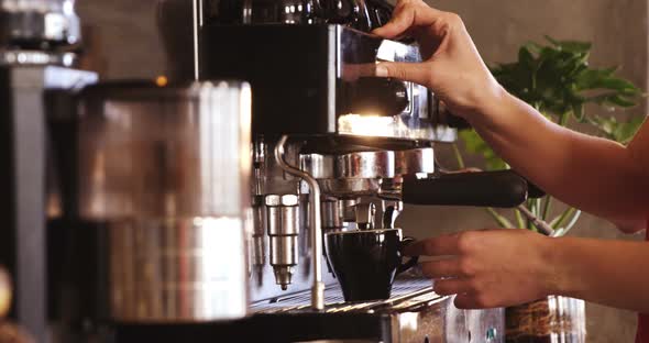 Waitress making cup of coffee