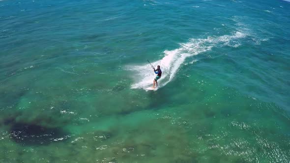 Aerial view of a man kitesurfing in Hawaii