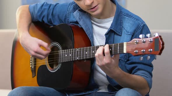 Interested Teenager Playing Acoustic Guitar, Amateur Musical Hobby, Free Time