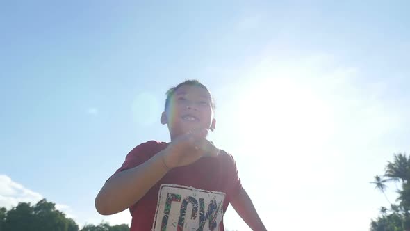 Asian Boy Running With Sun