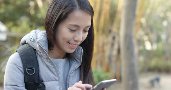 Woman use of mobile phone in the park