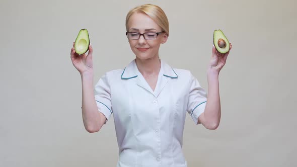 Nutritionist Doctor Healthy Lifestyle Concept - Holding Organic Avocado