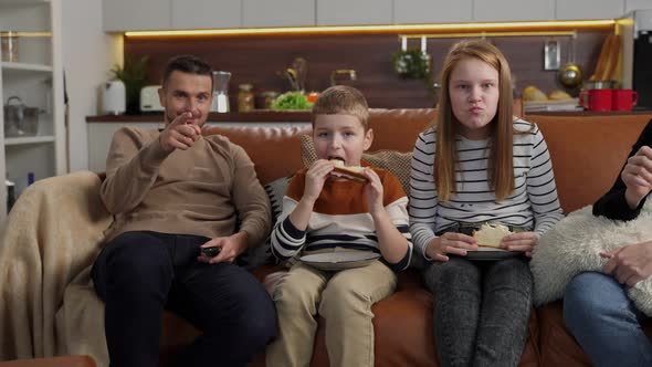 Positive Deaf Family Watching TV Sitting on Sofa