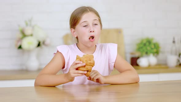 Girl Eating Croissant