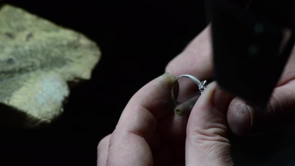 Closeup of Wedding Ring Polishing By Caicasian Jeweler Isolated  Footage