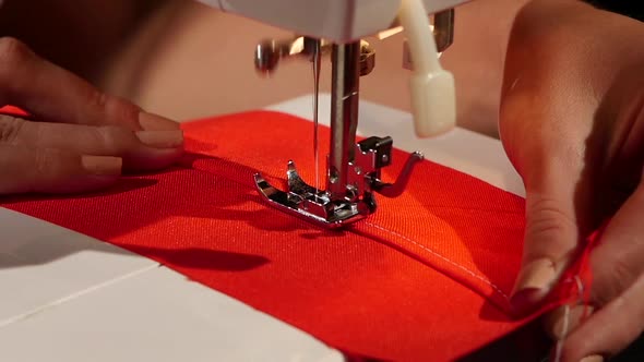 White Stitch on a Red Fabric. Slow Motion