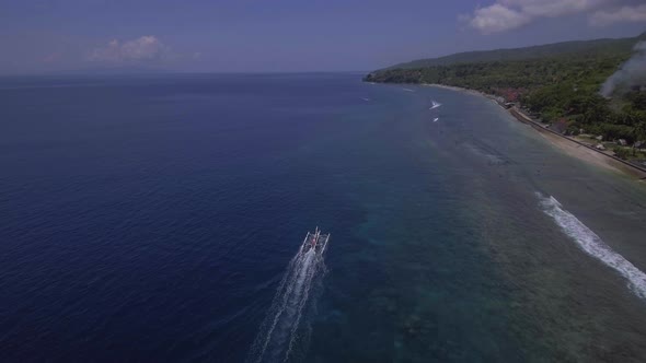 Aerial view of a fishing boat in clean blue water. Nusa Penida island, Indonesia.