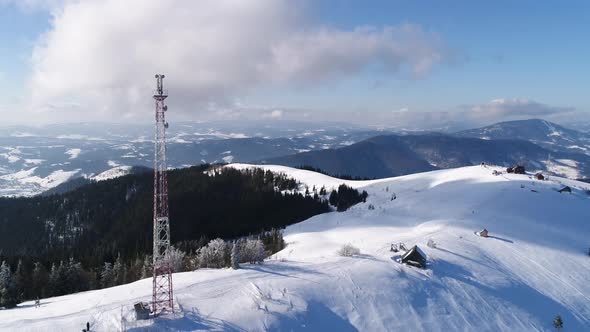 Flying Over Radio Communications Tower, Mountain Snow Covered Winter Landscape.