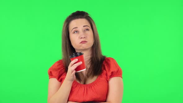 Portrait of Cute Girl Is Drinking Coffee and Then Enjoying. Green Screen