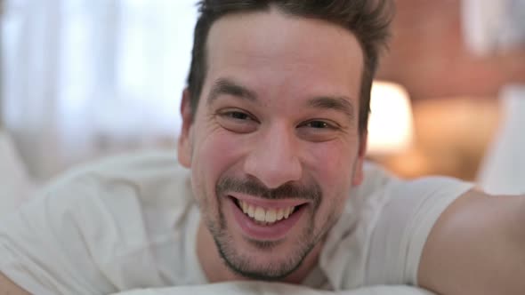 Close Up of Cheerful Young Man Doing Video Chat 