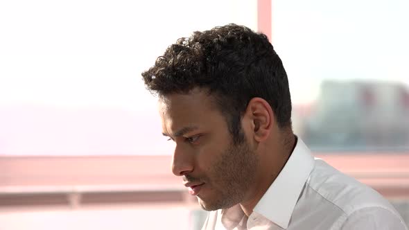 Smiling Indian Man Face While Typing.