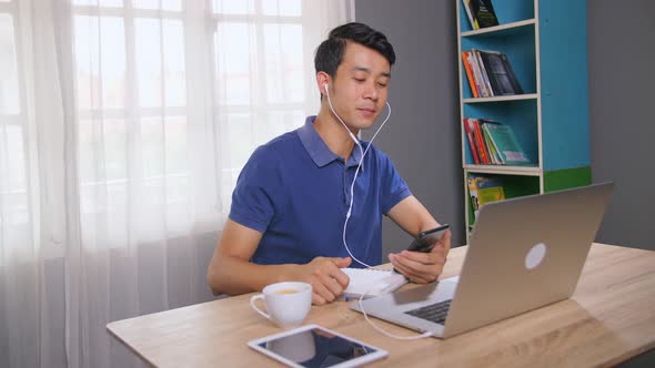 Executive Enjoying While Listening And Singing Music At Workplace