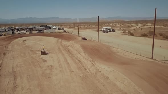 Dramatic slomo jump at UTV dirt track racing, Mojave Desert, AERIAL