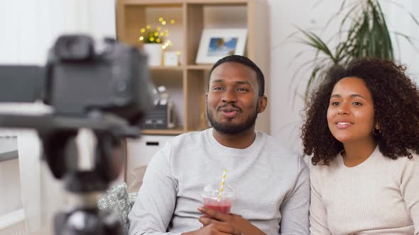 Couple of Video Bloggers with Camera at Home