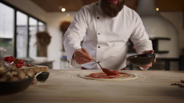 Professional Cook Making Pizza in Culinary Kitchen