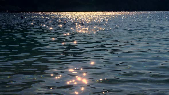 Close-up. the Sun's Rays Are Reflected in Sea Water, in Soft Waves, at Sunset.