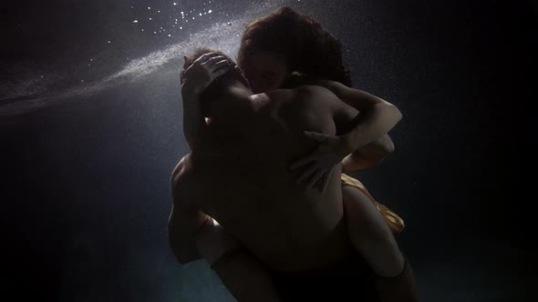 Young Man and Woman Are Having Sex Underwater Medium Shot of Muscular Naked Male Back Slow Motion