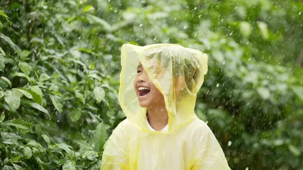 Happy boy wears raincoat