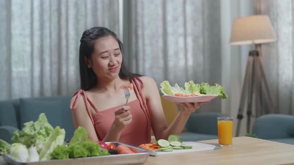 Asian Woman Shaking Her Head Due To Hating Eating Healthy Food While Having A Meal At Home
