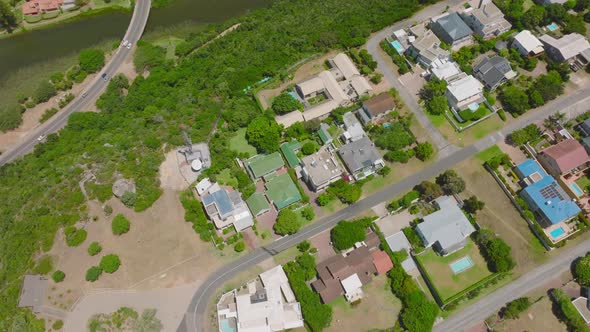 Birds Eye View of Group of Luxury Residences on Hill Above Valley with River