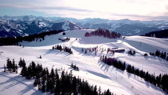 People skiing and snowboarding on snow slope in winter ski resort. Ski elevator on snow mountain. Wi