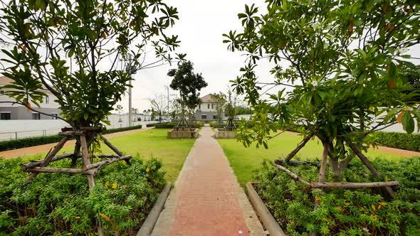 Modern Park With Green Grass and Brick Jogging Track