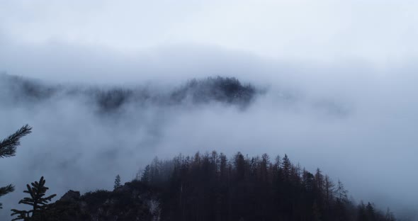 Slow drifting autumn fog over mountains in Triglav Slovenia