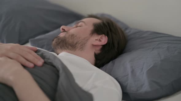 Young Man Unable to Sleep in Bed