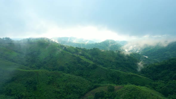 4K Aerial Drone shot flying over beautiful mountain ridge in rural jungle bush forest.