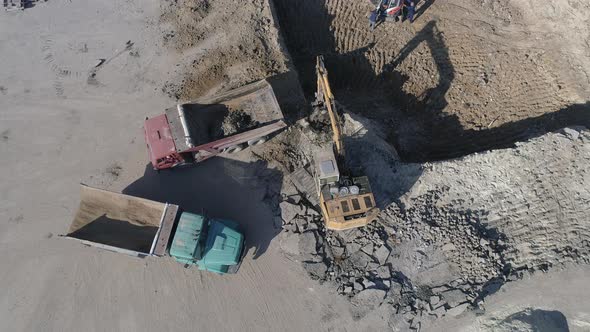 Aerial view of an excavator loading a truck