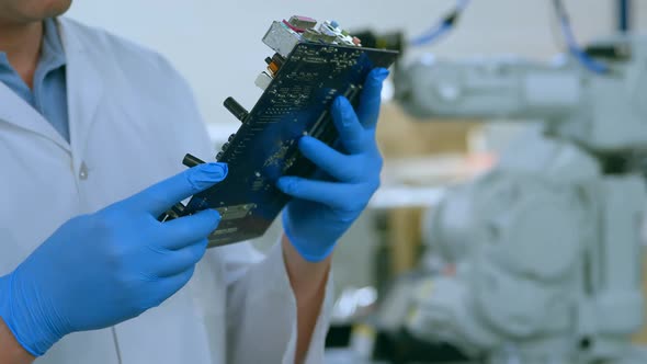 Mid section of robotic engineer examine circuit board 4k