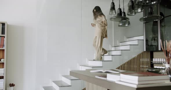 Slow Motion Photo of a Young Independent Caucasian Woman Coming Down the Stairs