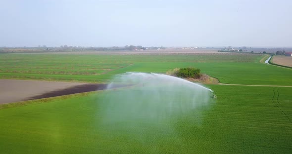 A Jet of Water is Sprayed on the Green Field