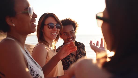 Friends Smiling Laughing Speaking Walking at Seaside at Sunrise