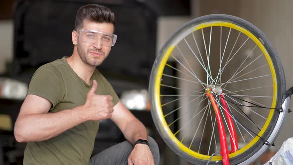 Mechanic repairing bicycle in workshop