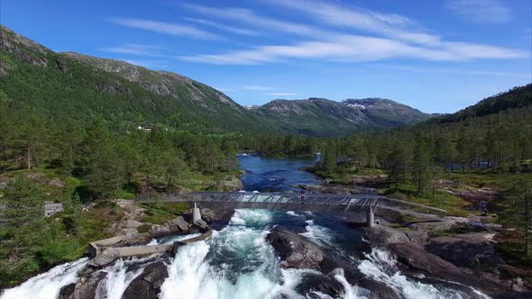 Young girl watching waterfall in Norway