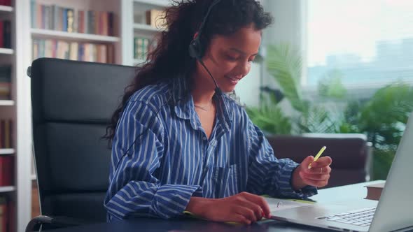 Indian Female Student in Headphones Look at Laptop Screen Study Online From Home