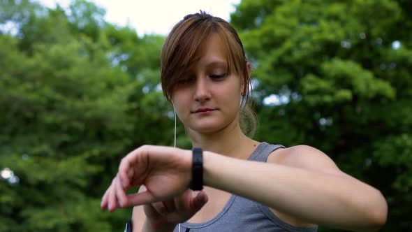 Girl in Nature Turns on the Music Through the Clock and Closes Her Eyes