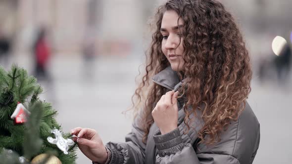 Portrait of a Young Woman with Curly Hair She Is on a City Street on a Cold Winter Day