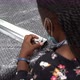 African American woman screwing a screw inside a metal rod on top of bubble wrap. slow motion - VideoHive Item for Sale